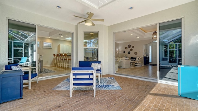 view of patio / terrace featuring ceiling fan and a lanai