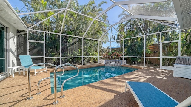 view of pool featuring a patio and glass enclosure