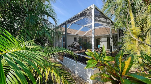 view of patio featuring a lanai