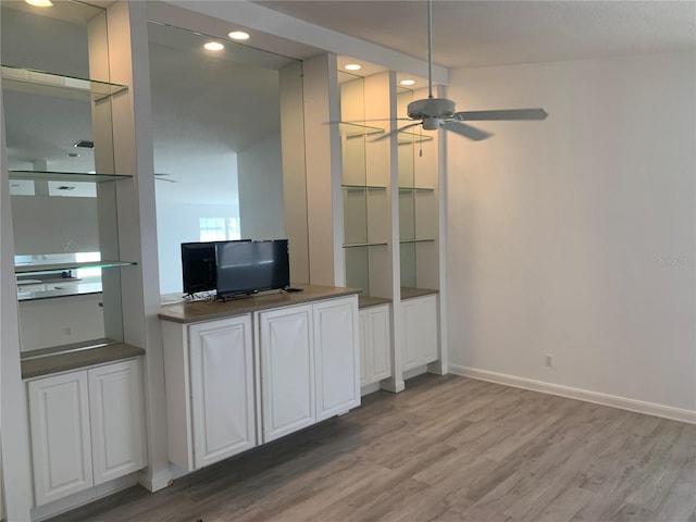 unfurnished living room featuring wood-type flooring and ceiling fan