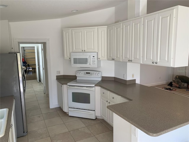 kitchen with white cabinetry, white appliances, kitchen peninsula, and light tile patterned floors