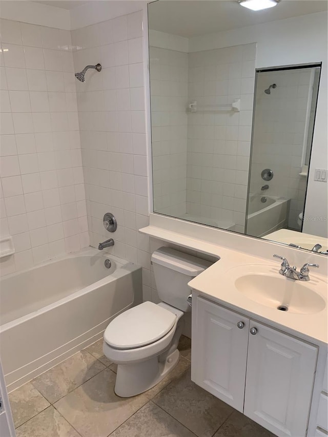 full bathroom with vanity, tiled shower / bath combo, toilet, and tile patterned flooring