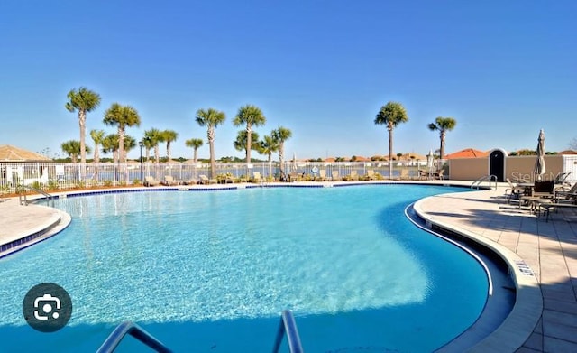 view of swimming pool featuring a patio area