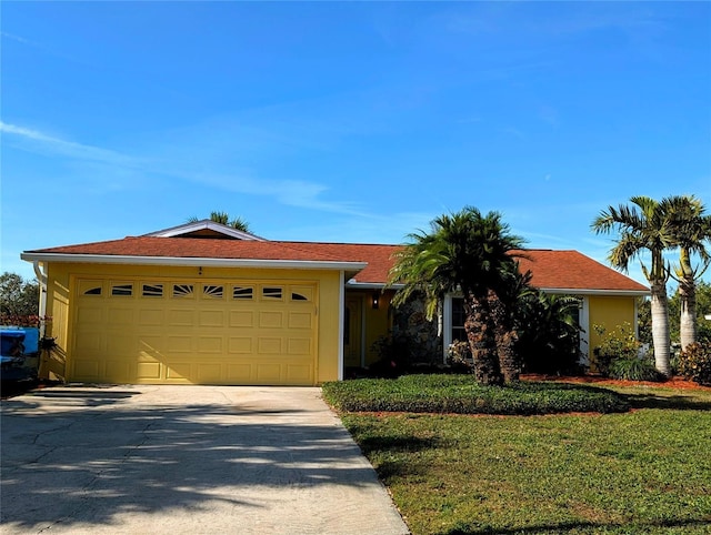 ranch-style home with a front lawn and a garage