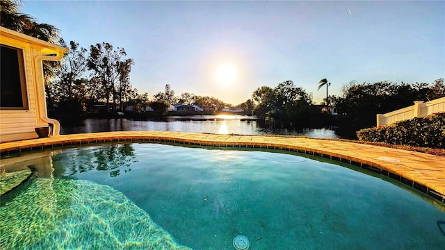 pool at dusk with a water view