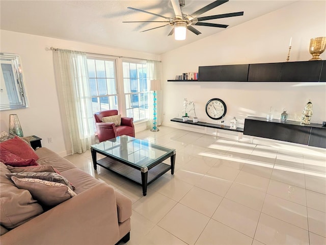 living room featuring ceiling fan, light tile patterned floors, and vaulted ceiling