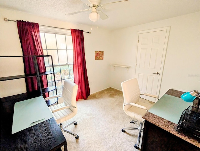 office area featuring ceiling fan, a healthy amount of sunlight, carpet floors, and a textured ceiling