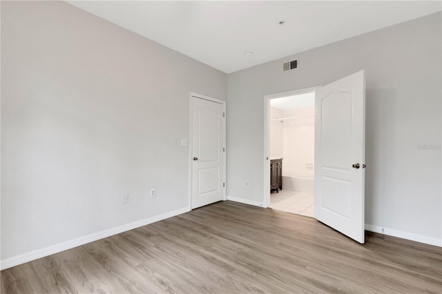 spare room with light hardwood / wood-style floors