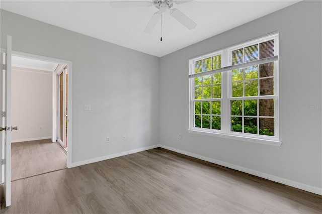 empty room with ceiling fan and light wood-type flooring