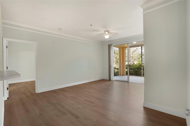 spare room with ornamental molding, dark wood-type flooring, and ceiling fan