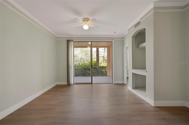 empty room featuring hardwood / wood-style flooring, ceiling fan, and ornamental molding