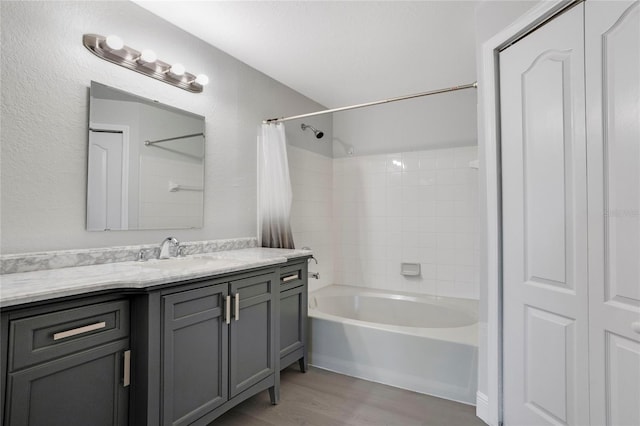 bathroom featuring vanity, hardwood / wood-style flooring, and shower / bath combo with shower curtain