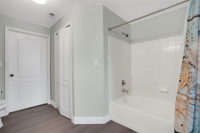 bathroom featuring shower / bath combo and hardwood / wood-style floors