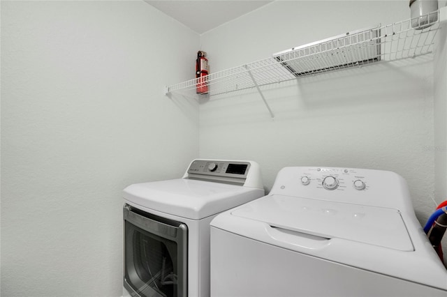 laundry room with washing machine and clothes dryer