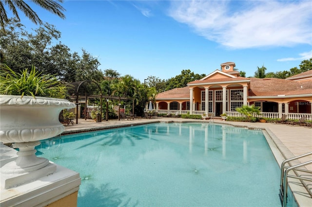 view of swimming pool with a water slide and a patio area