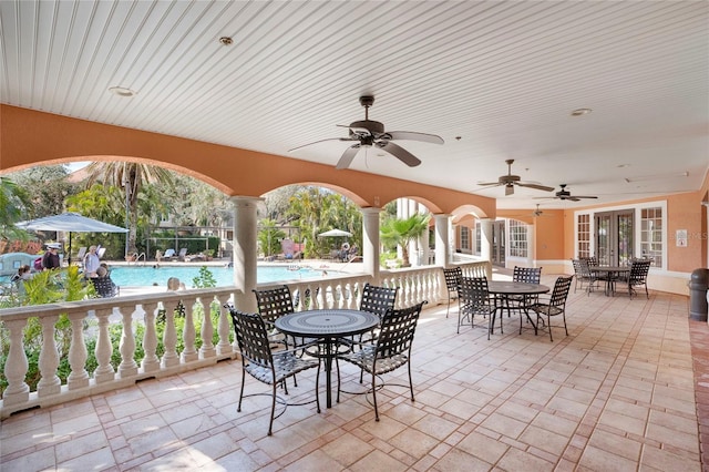 view of patio / terrace with a community pool, french doors, and ceiling fan