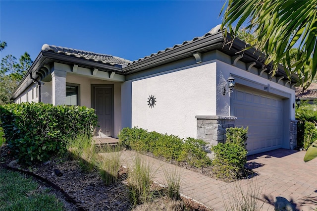 doorway to property with a garage