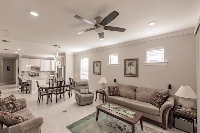 living room featuring ceiling fan and ornamental molding