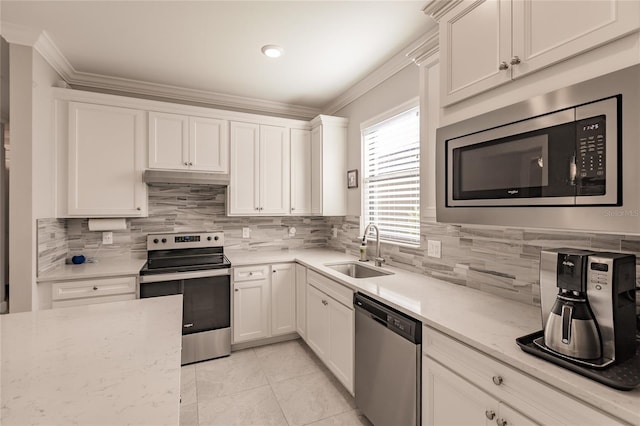 kitchen with tasteful backsplash, white cabinetry, sink, and appliances with stainless steel finishes