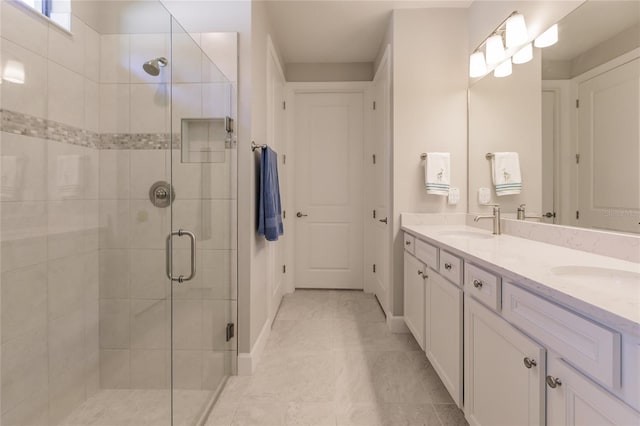 bathroom with tile patterned flooring, vanity, and a shower with shower door