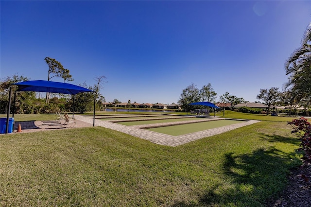 view of home's community with a yard