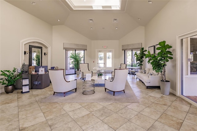 living room featuring light tile patterned floors, high vaulted ceiling, and french doors