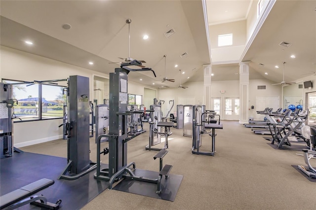 gym with ceiling fan and high vaulted ceiling