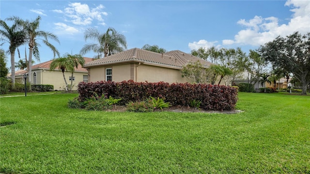 view of side of home featuring a lawn