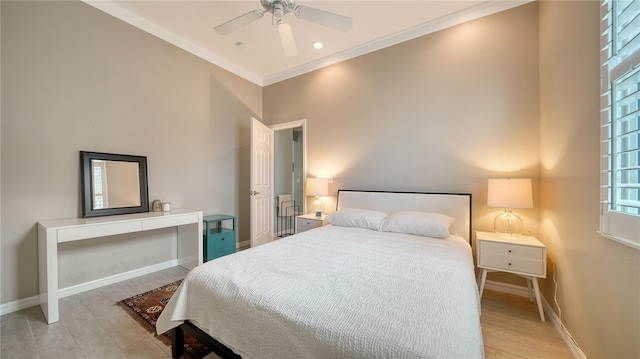 bedroom featuring ceiling fan, ornamental molding, and light hardwood / wood-style flooring