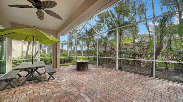 unfurnished sunroom featuring ceiling fan