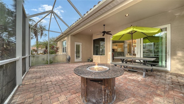 sunroom featuring a wealth of natural light and ceiling fan