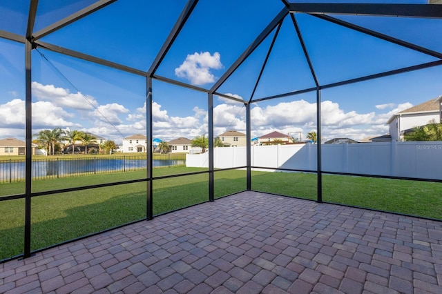 unfurnished sunroom with a water view