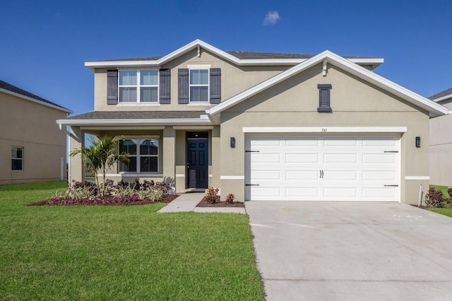 traditional-style home with a front yard, concrete driveway, an attached garage, and stucco siding