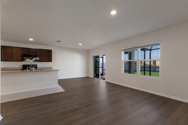 unfurnished living room featuring dark wood-type flooring