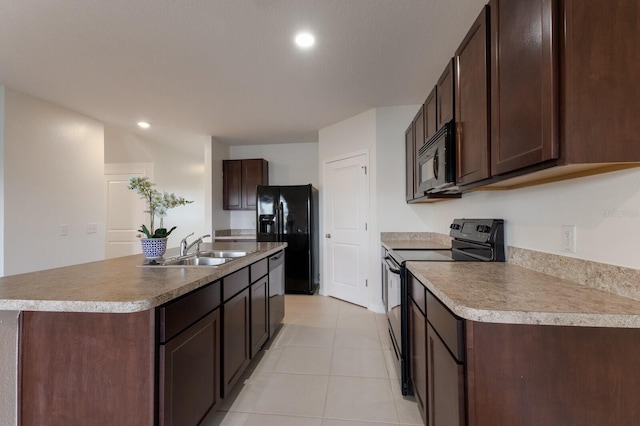 kitchen featuring dark brown cabinets, a kitchen island with sink, sink, and black appliances