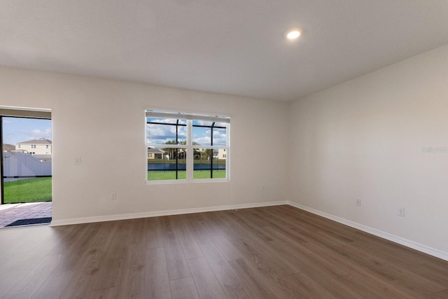 empty room with dark hardwood / wood-style floors