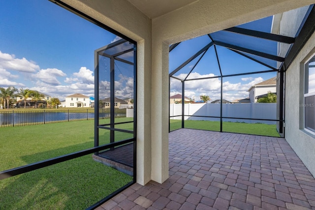 unfurnished sunroom with a water view