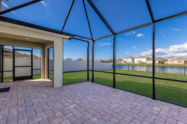 unfurnished sunroom featuring a water view and a healthy amount of sunlight