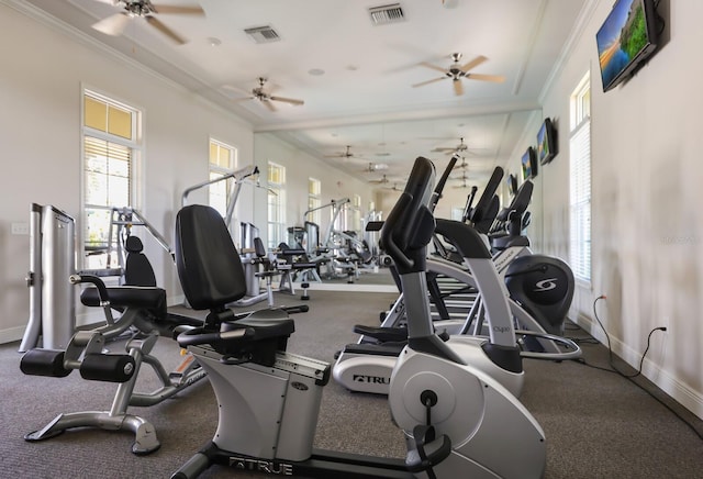 workout area featuring ceiling fan and ornamental molding