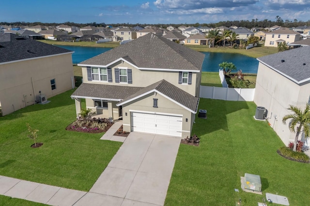 view of front of house with central AC unit, a front yard, and a water view