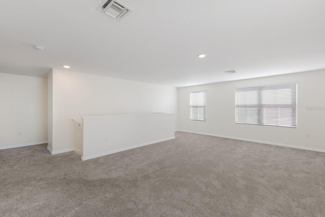 unfurnished room with light colored carpet