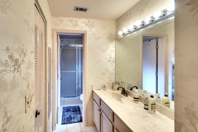 bathroom featuring toilet, tile patterned flooring, a textured ceiling, and walk in shower