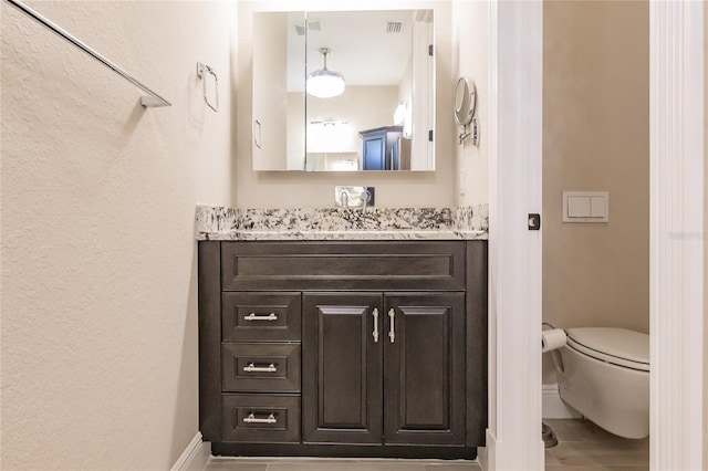 bathroom with vanity and toilet