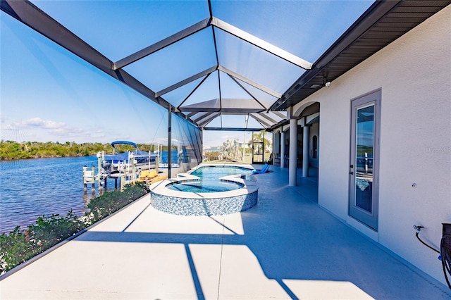 view of patio / terrace featuring a water view, a lanai, and a pool with hot tub