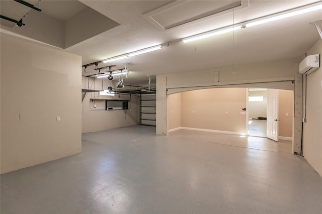 garage featuring a garage door opener and a wall mounted AC