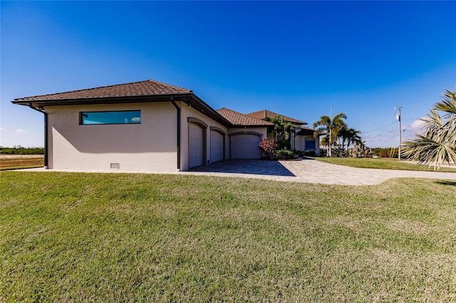 view of side of home with a yard and a garage