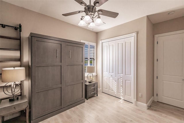 bedroom with a closet, ceiling fan, and light hardwood / wood-style flooring