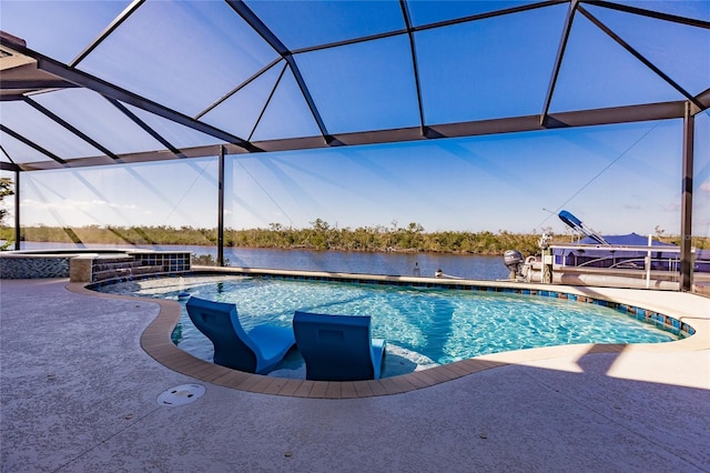 view of swimming pool with a lanai, a patio area, and a water view