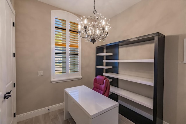 home office featuring light hardwood / wood-style floors and a chandelier