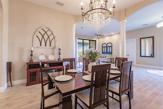 dining space featuring light wood-type flooring, ornate columns, and ceiling fan